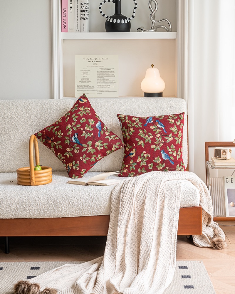 Red bird floral cushion on a cream sofa, cottage style