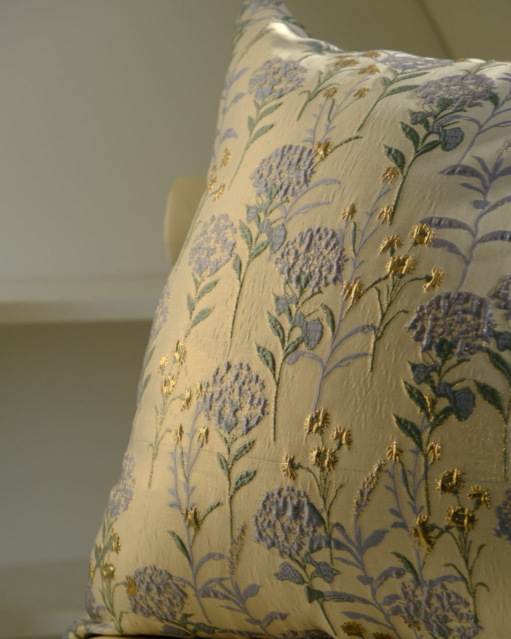 Floral embroidered pillow on a neutral background