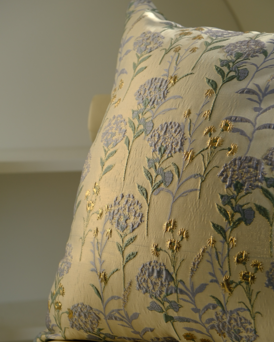Floral embroidered pillow on a neutral background
