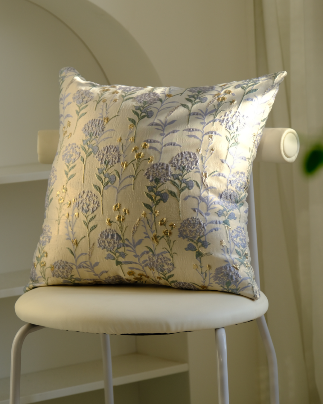Blue floral cushion on a chair, vintage botanical style