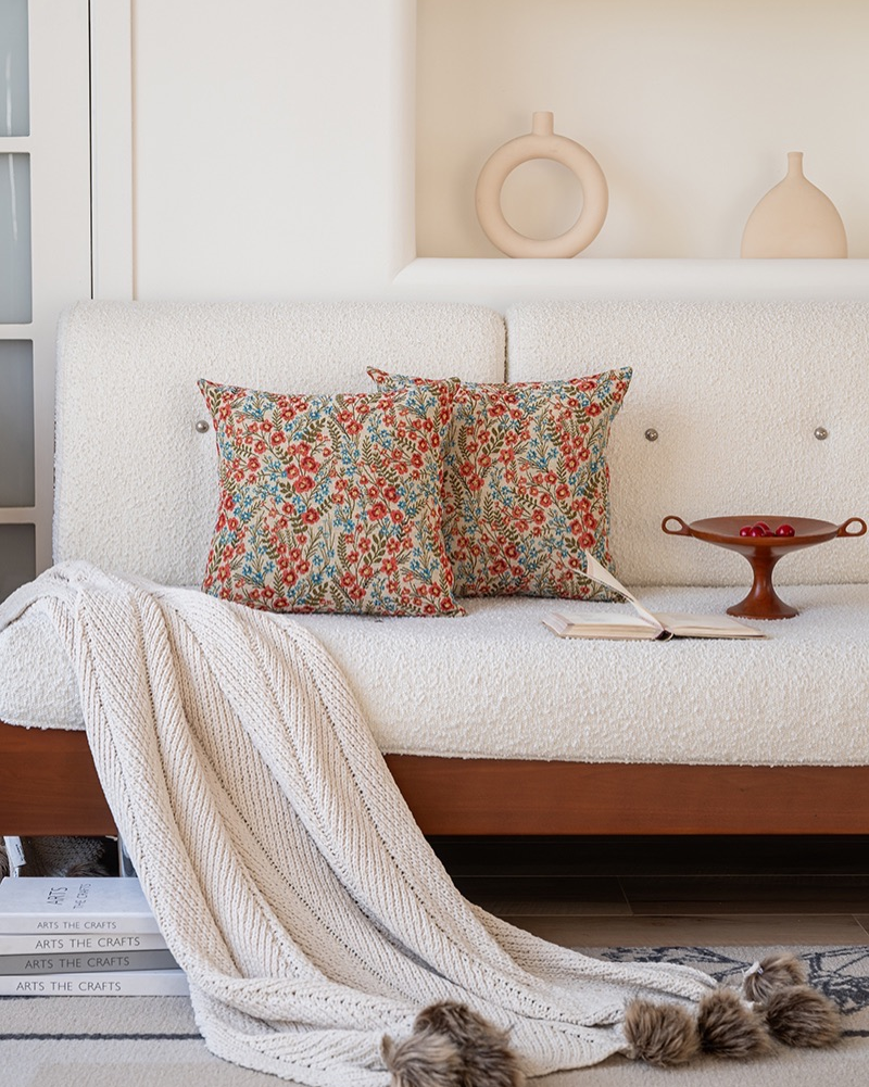 Red floral cushions on a cream sofa, cottage farmhouse style