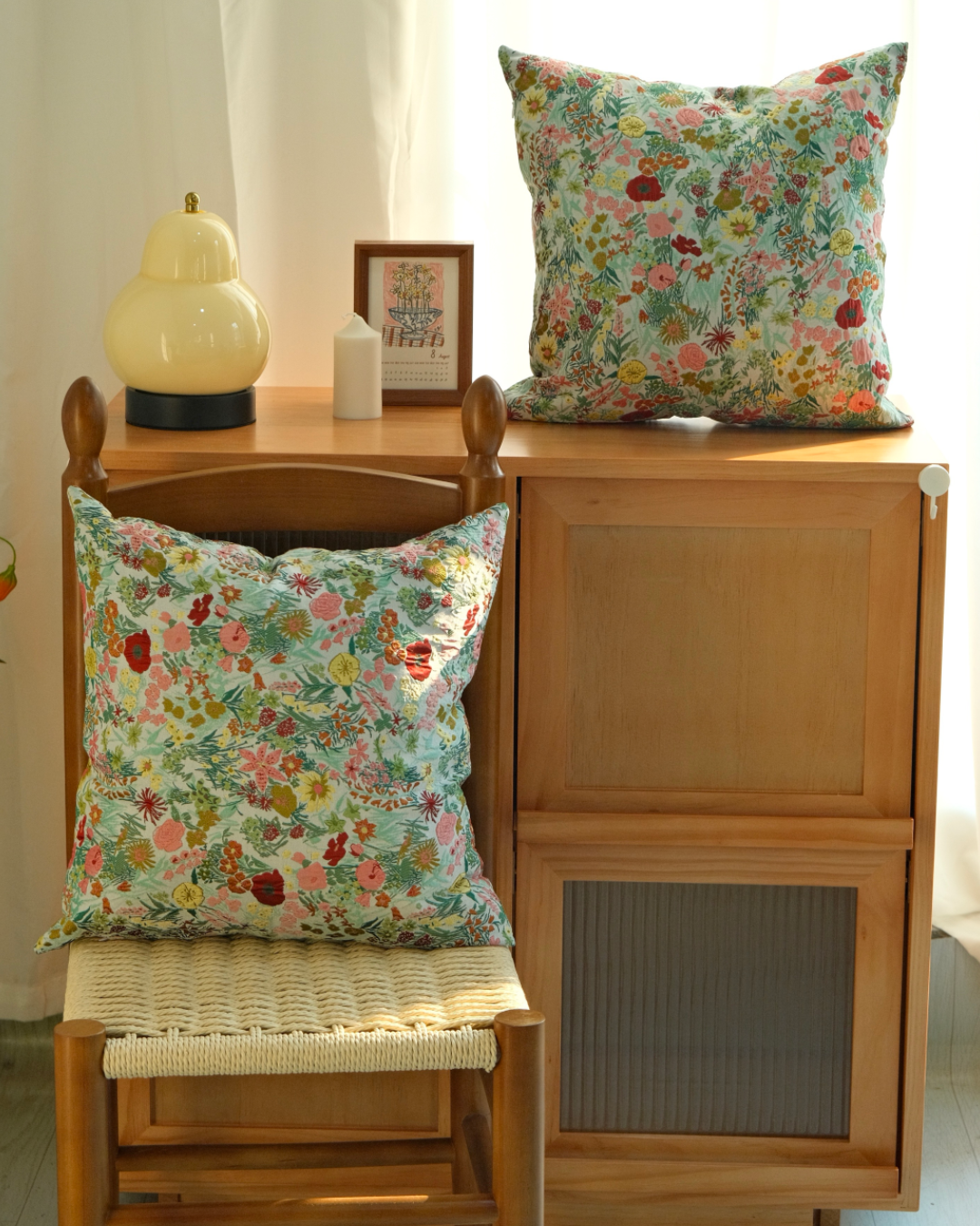 Two wildflower pillow covers styled on a bench