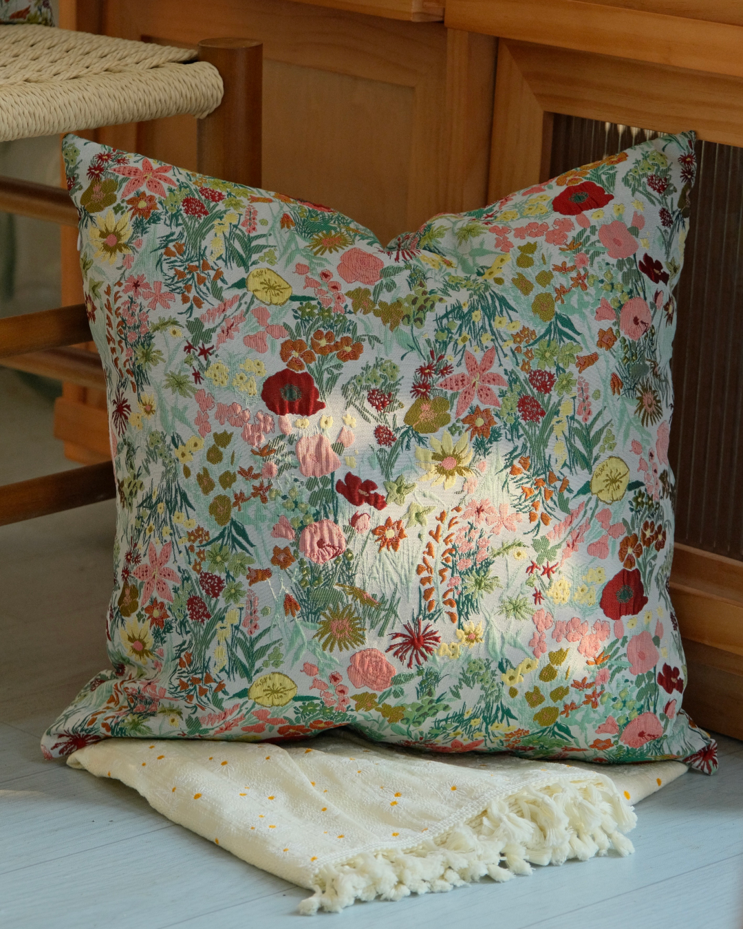 Close-up of dense multicolor wildflower print on cushion