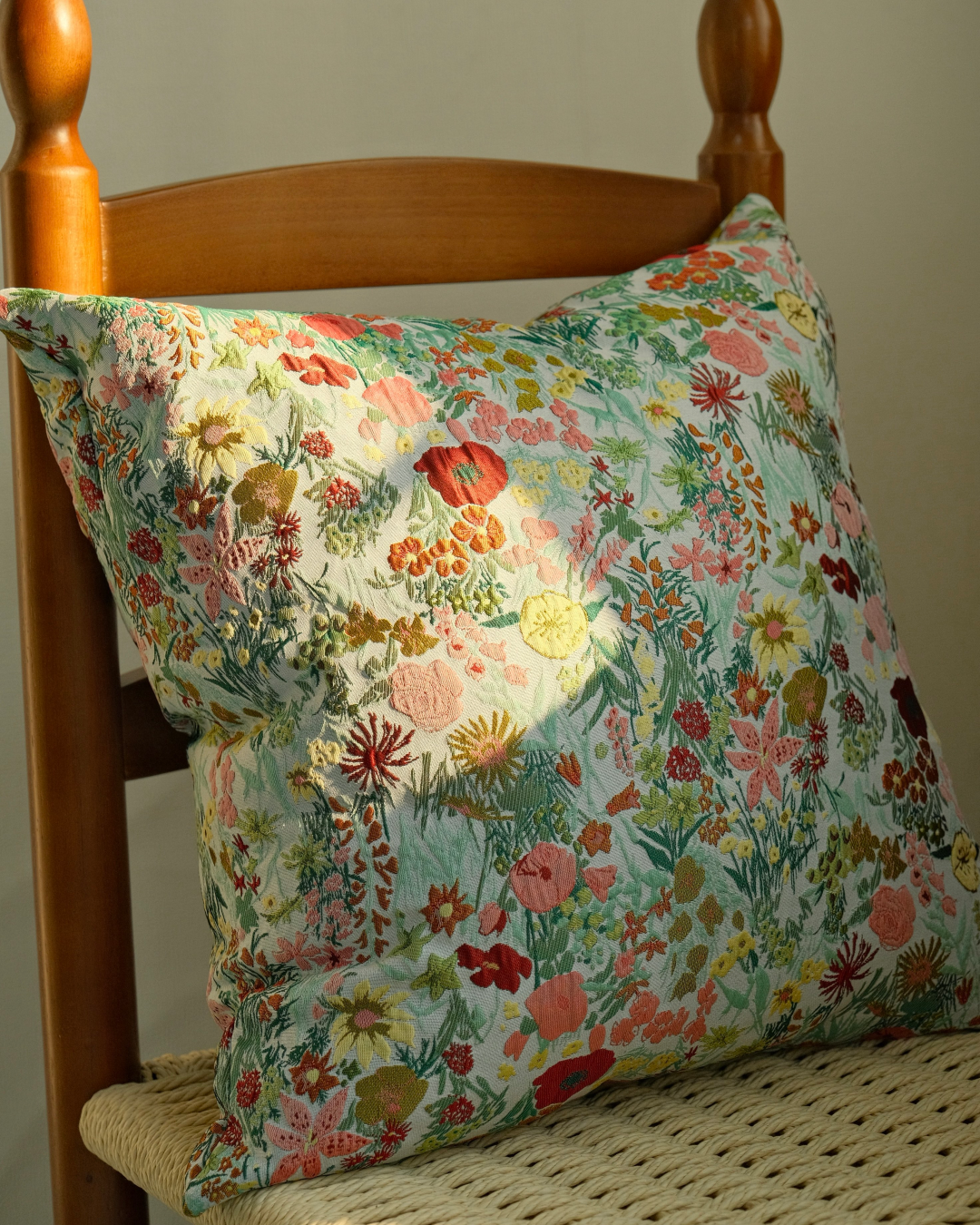Wildflower floral cushion on a wooden chair, cottage style