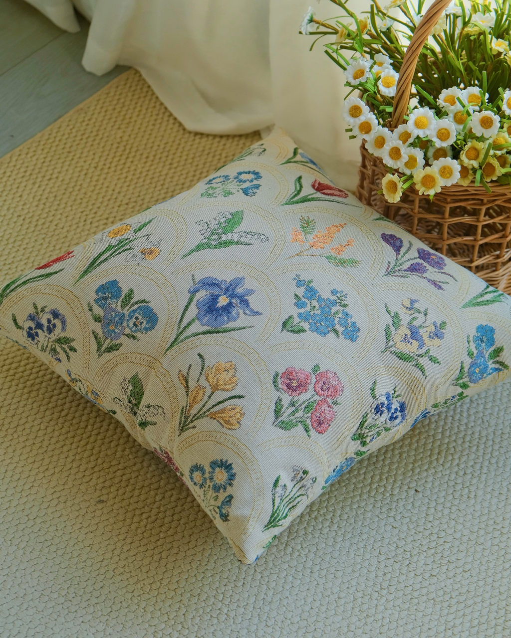 Watercolor floral pillow cover by a curtain with a flower basket