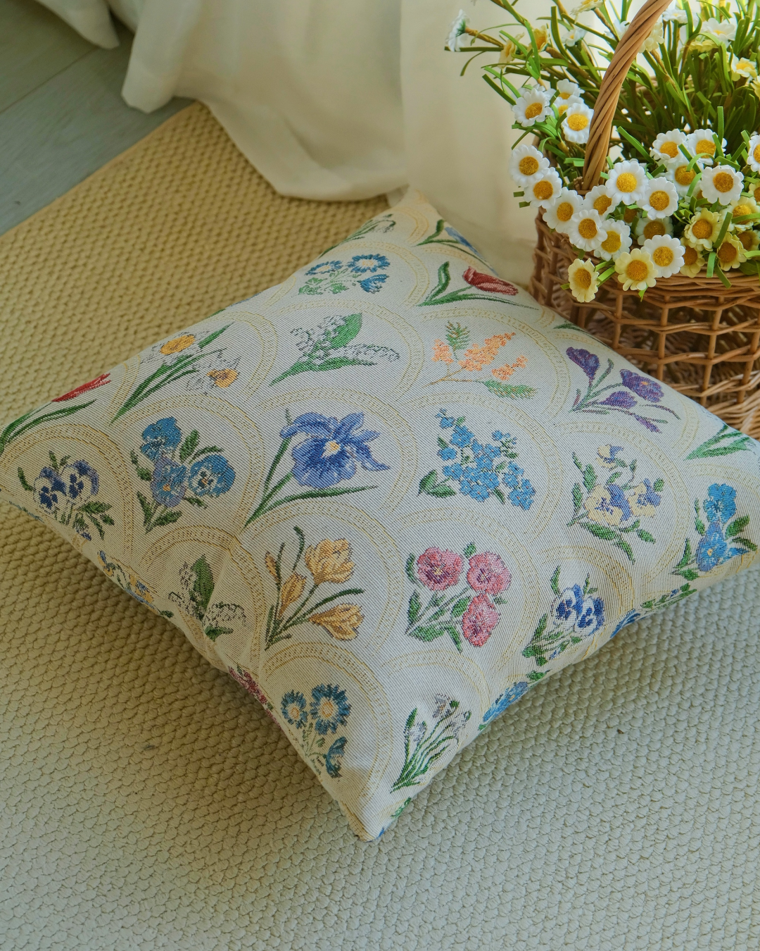 Watercolor floral pillow cover by a curtain with a flower basket