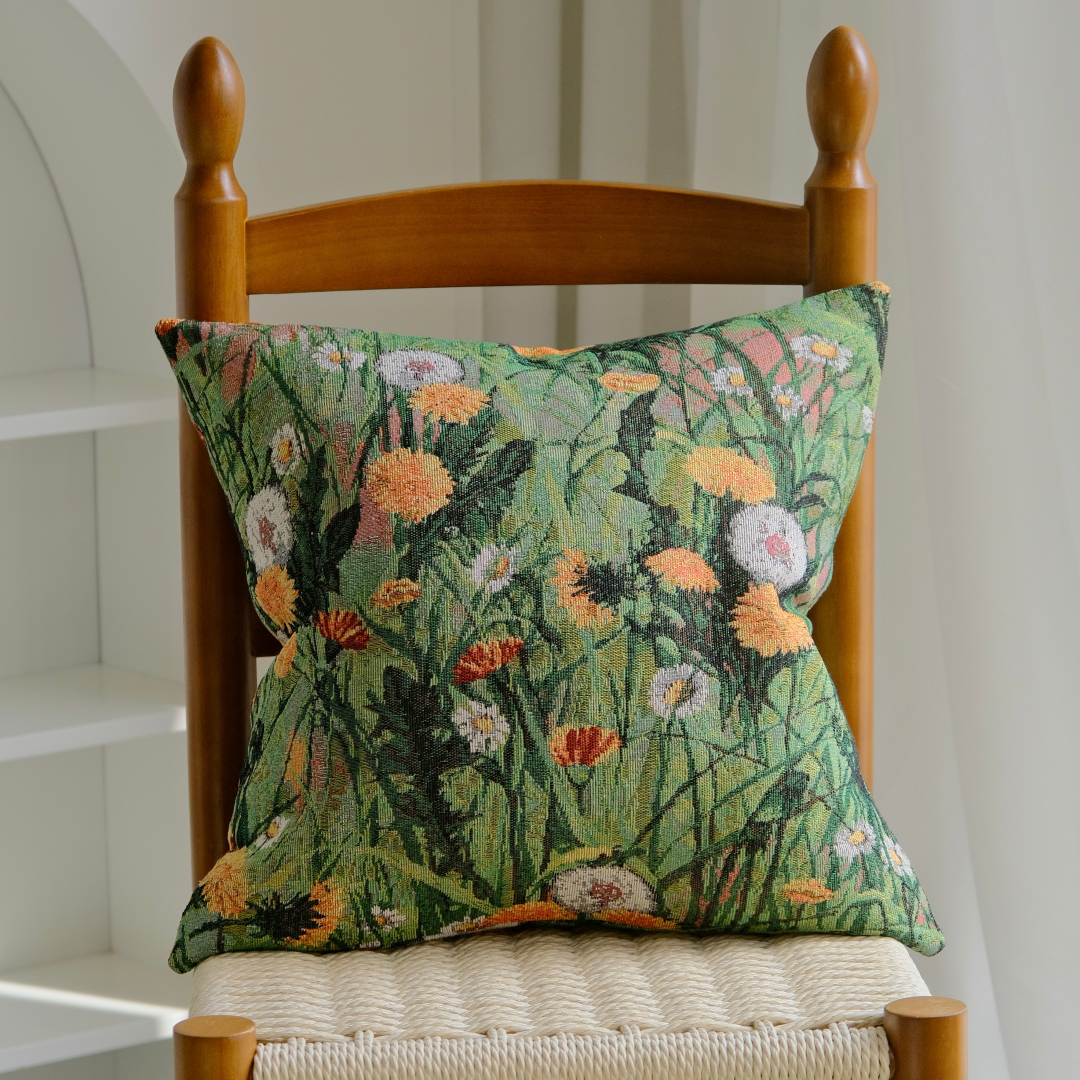 Wildflower meadow pillow cover on a wooden chair with woven seat