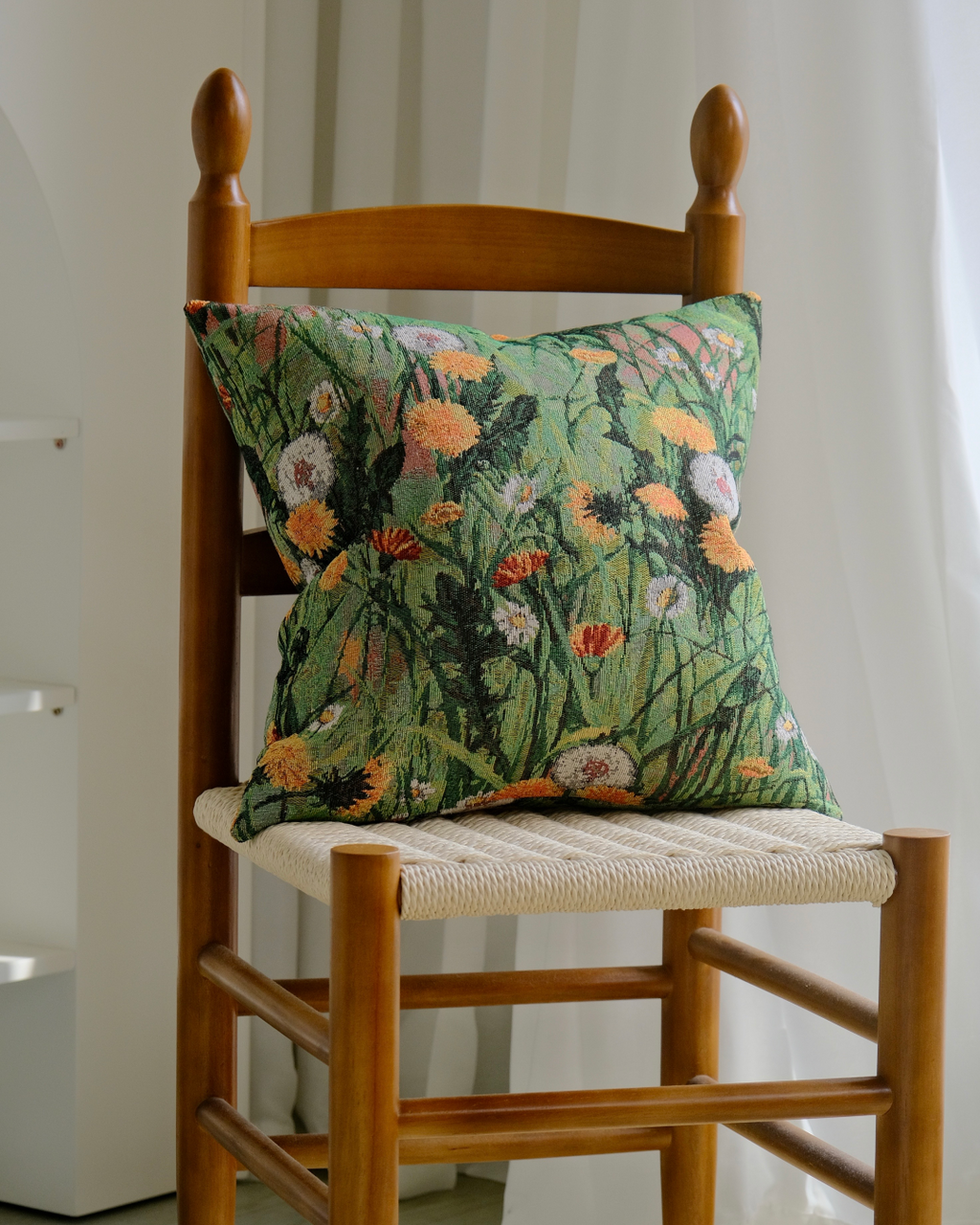 Wildflower meadow cushion cover on a rustic wooden chair
