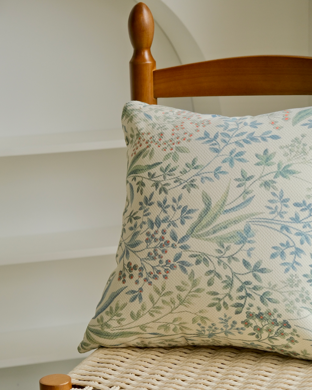 Sage sprig cushion cover on a chair showing full front print