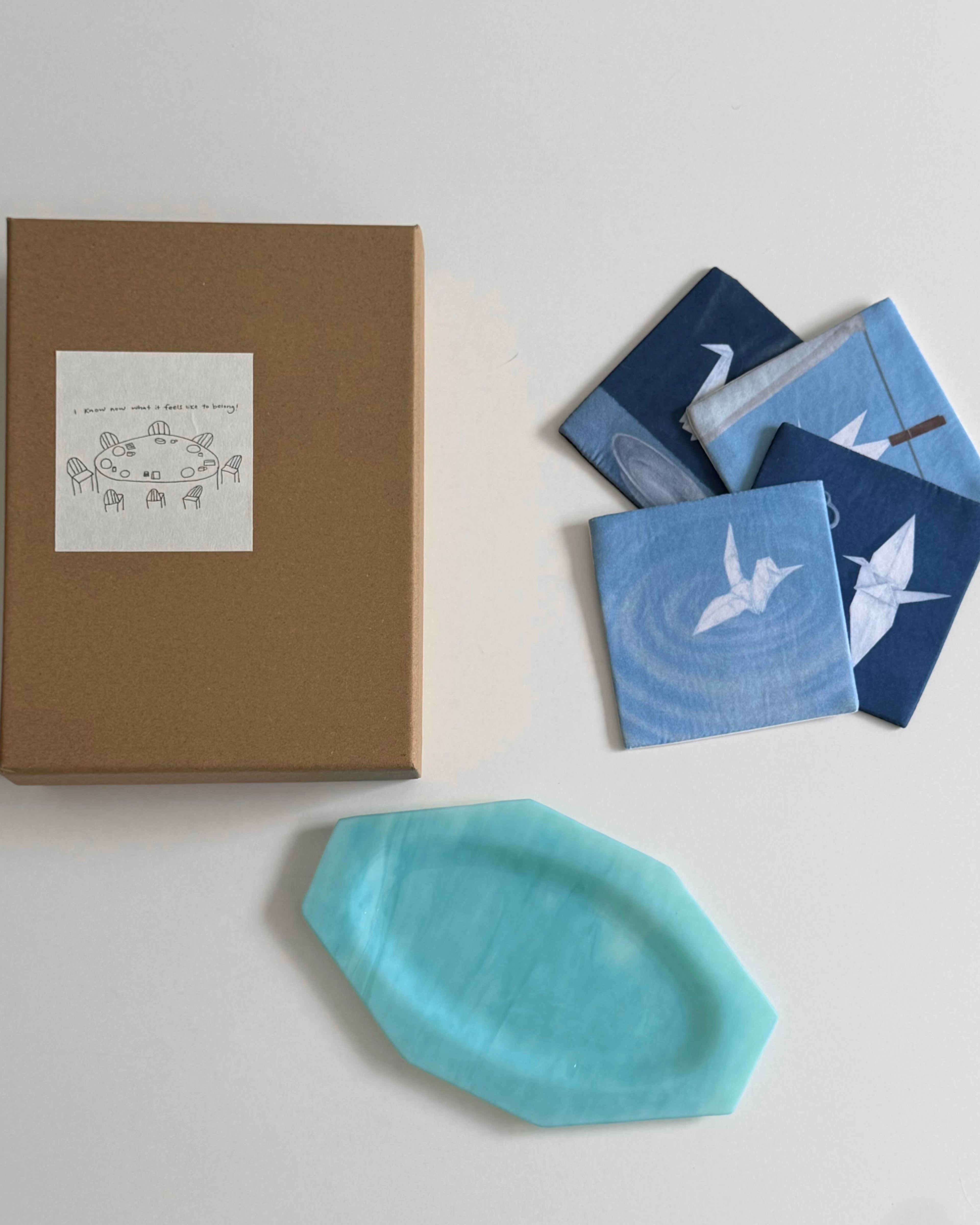 Cyanotype coaster set arranged with a gift box and teal glass tray