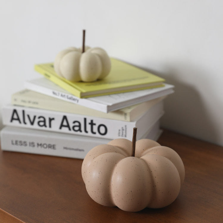 Minimalist ceramic pumpkin ornament on autumn table
