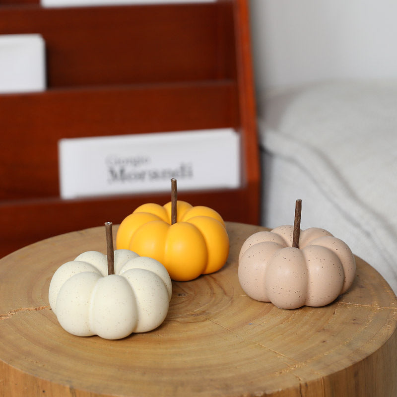 Glazed ceramic pumpkin decorations in seasonal colors
