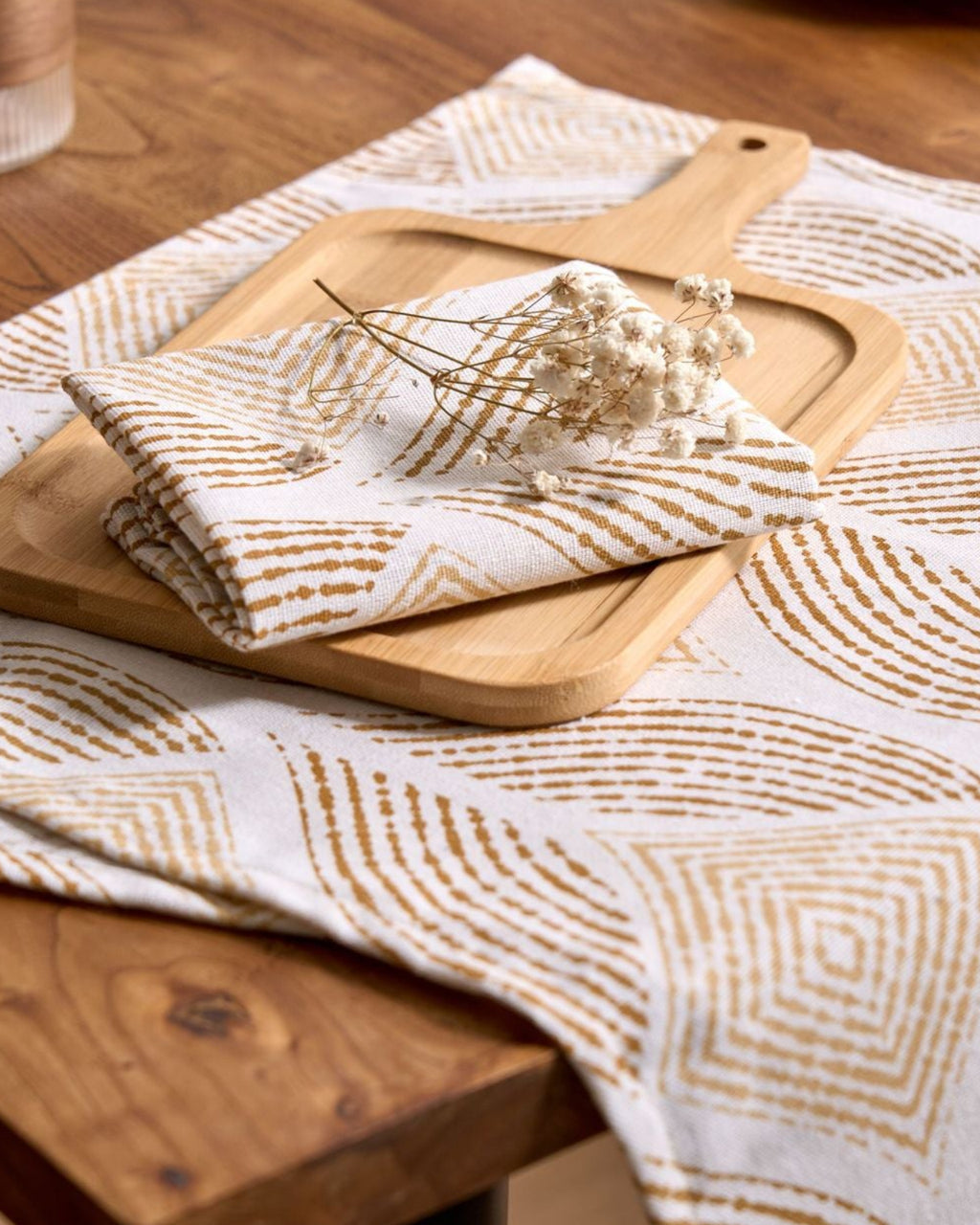 Close-up of mustard block-print pattern on cloth napkin