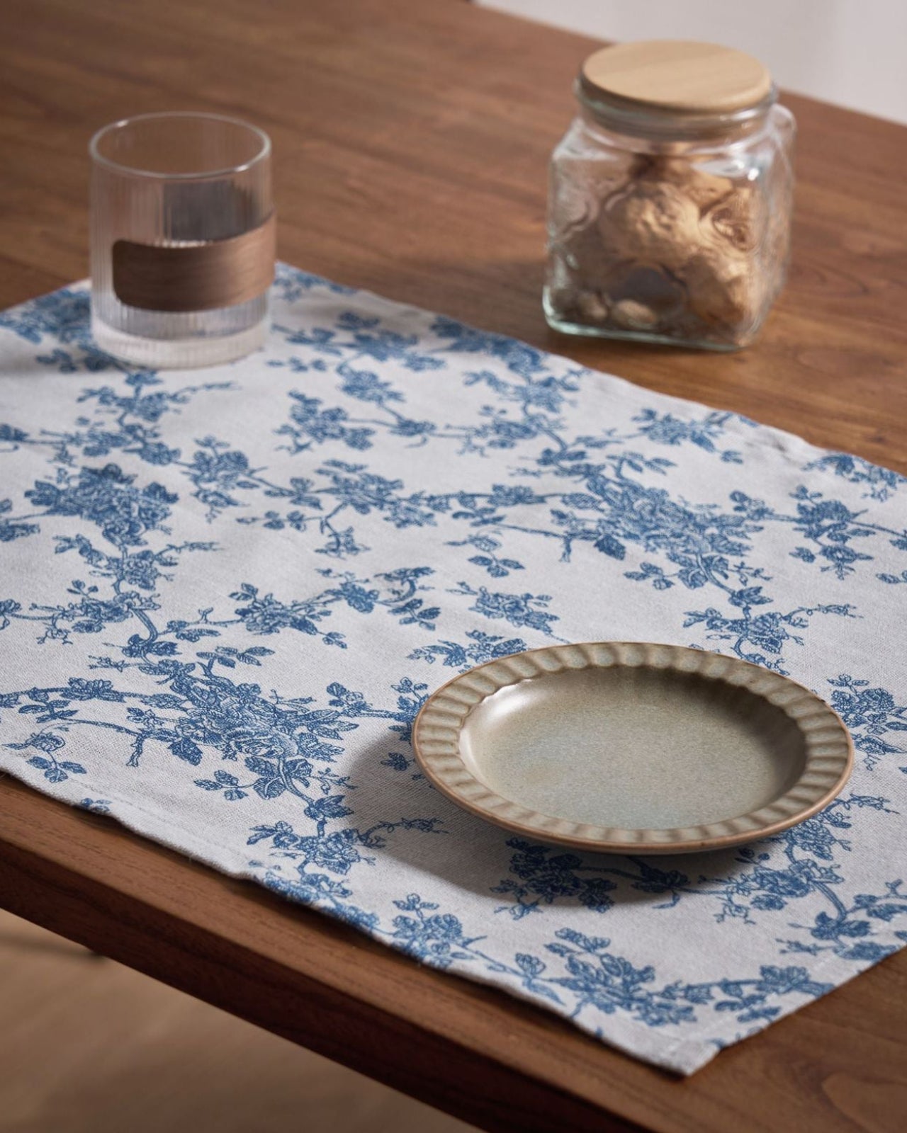 Blue floral cloth napkin under a plate, farmhouse table