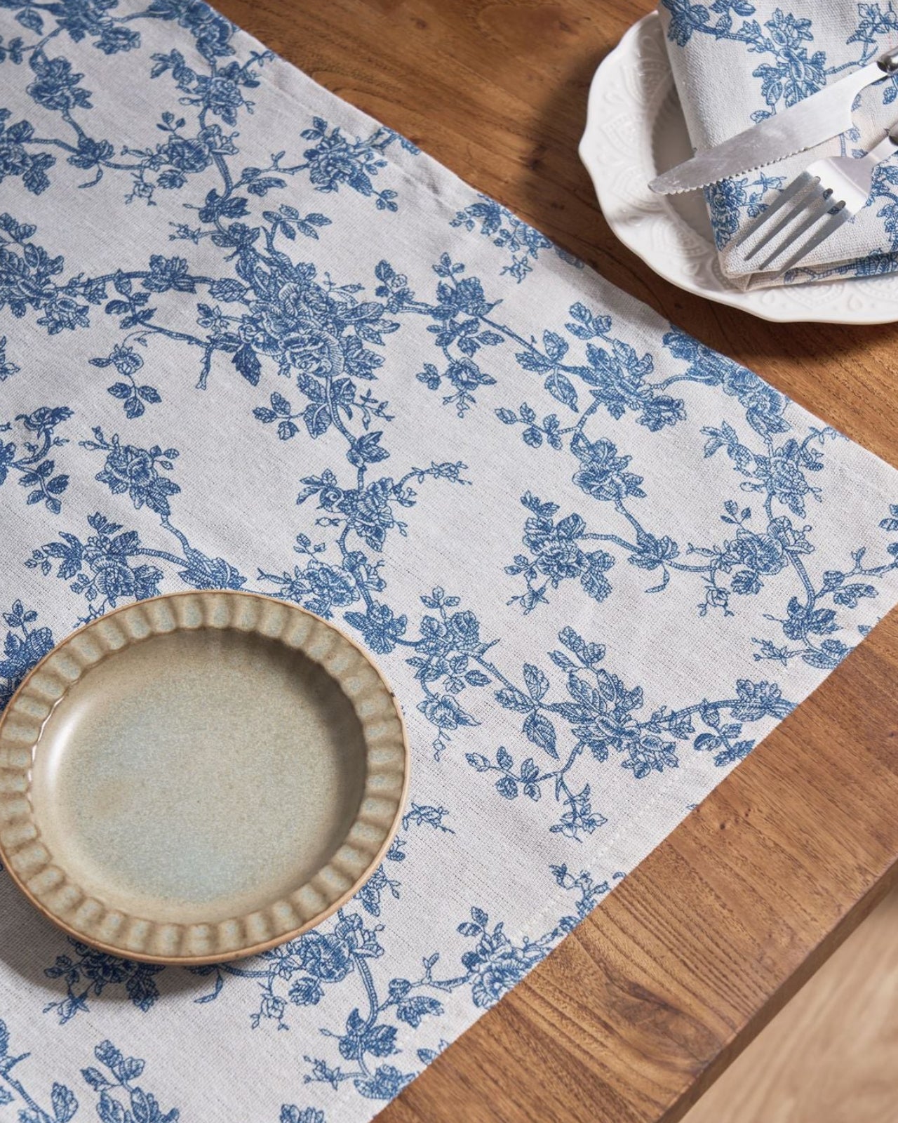 Close-up of blue floral toile print on cloth napkin