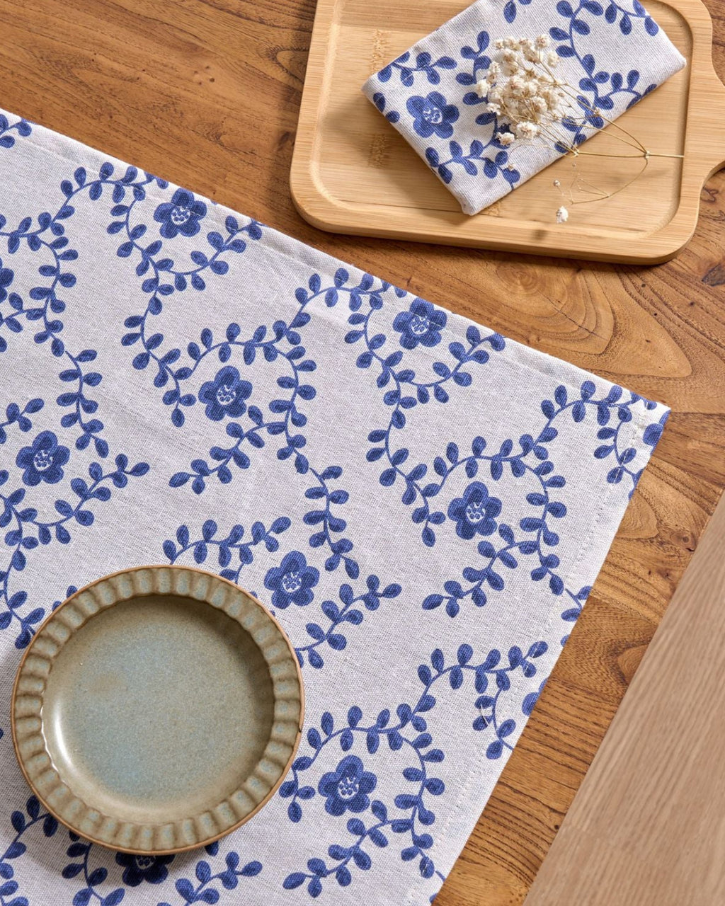 Close-up of blue ditsy floral vine print on napkin