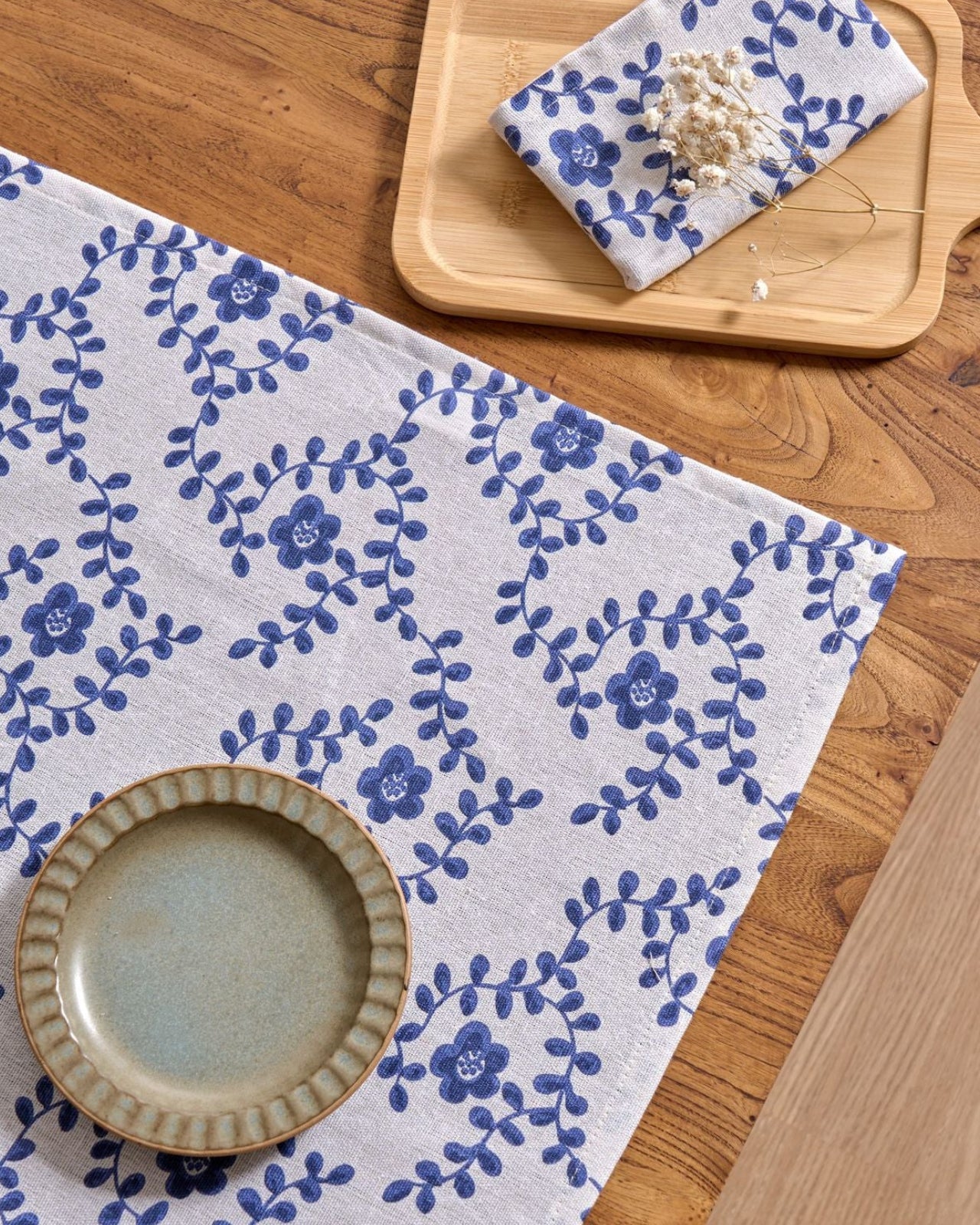 Close-up of blue ditsy floral vine print on napkin