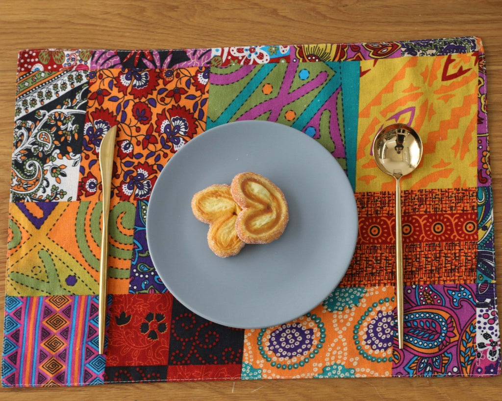 Bohemian patchwork placemat under a blue plate on wood table