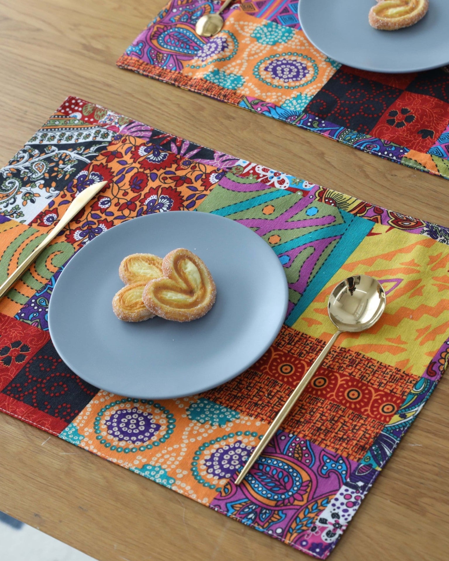 Two boho mandala placemats set on a dining table