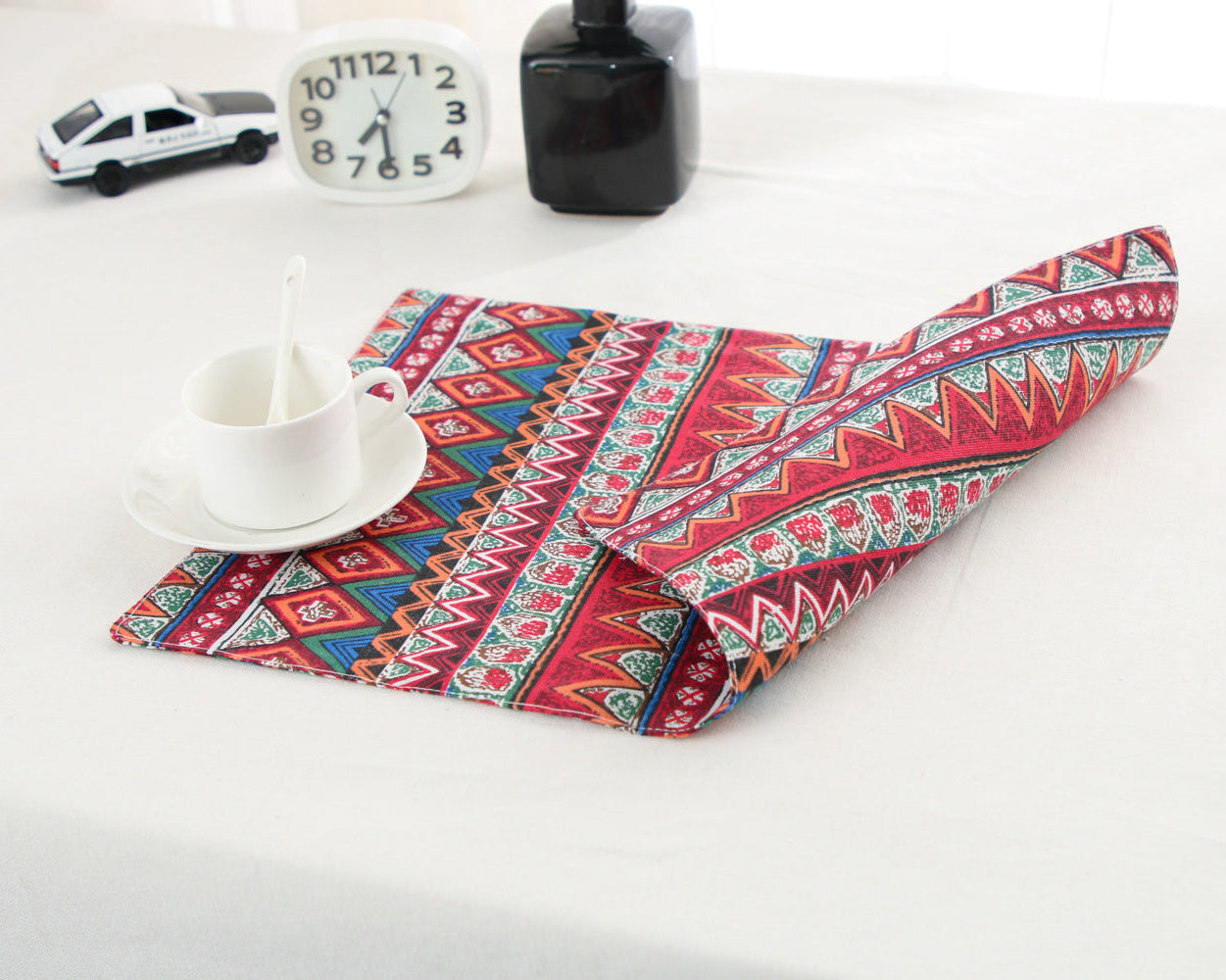Red tribal stripe placemat with cutlery on a table