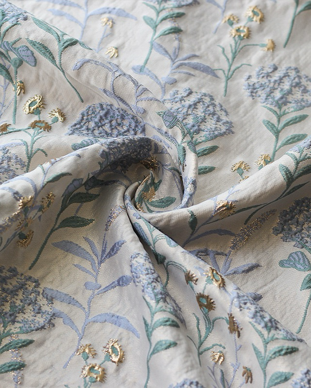 Close-up of Blue hydrangea tablecloth with embroidered details