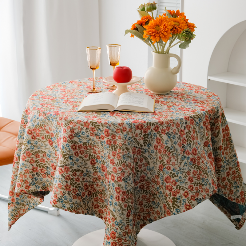 Wildflower floral tablecloth styled with a book and orange flowers