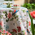 Rose Garden tasseled tablecloth draped over a round outdoor table