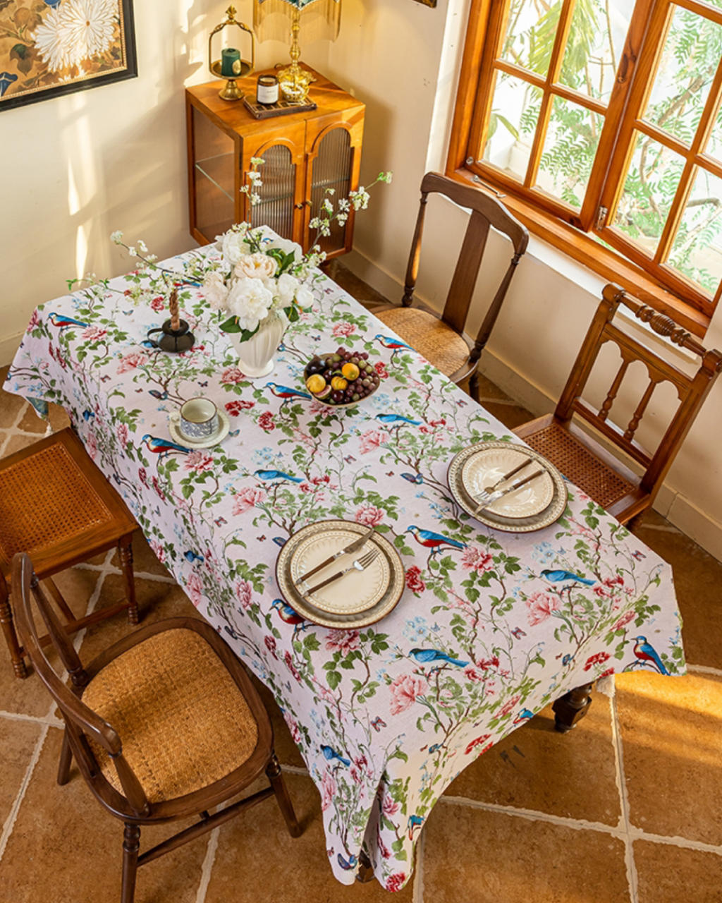 Rose Garden tasseled tablecloth on a set dining table with plates