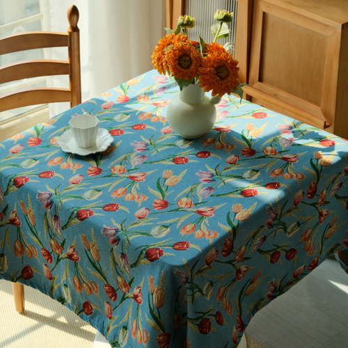 Blue tulip floral tablecloth styled on a round cottage dining table