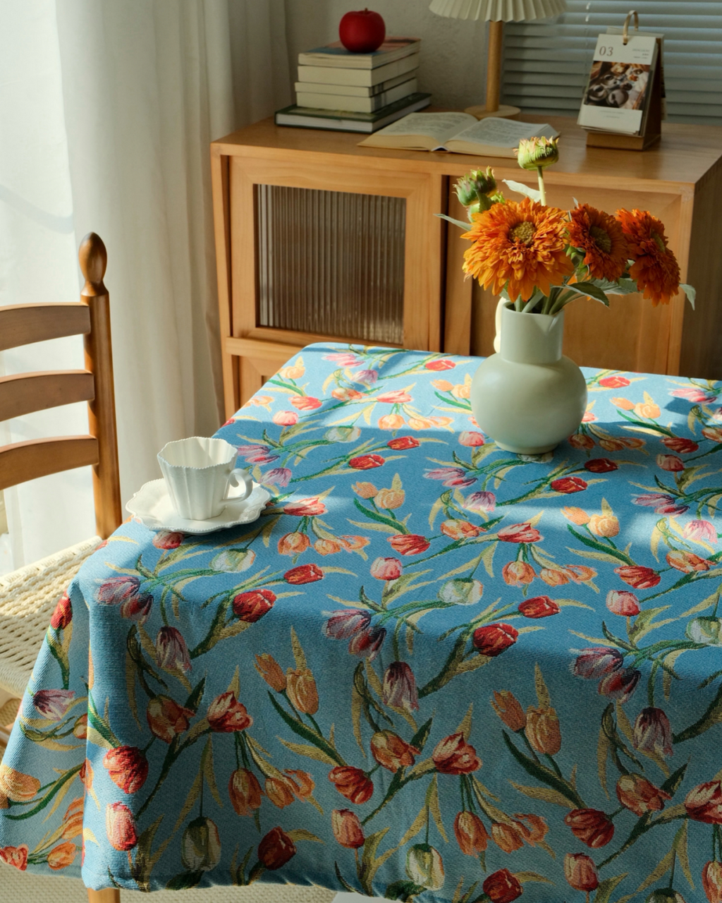 Cottage style blue botanical tablecloth with fresh flowers