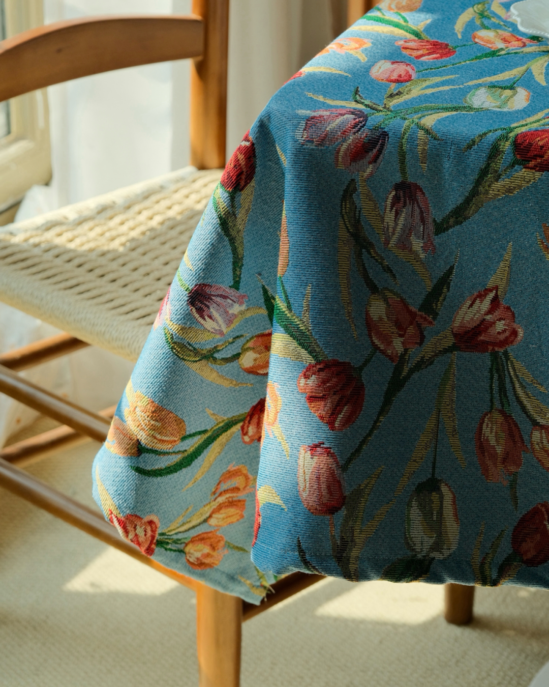 Draped blue tulip tablecloth over wooden dining chair