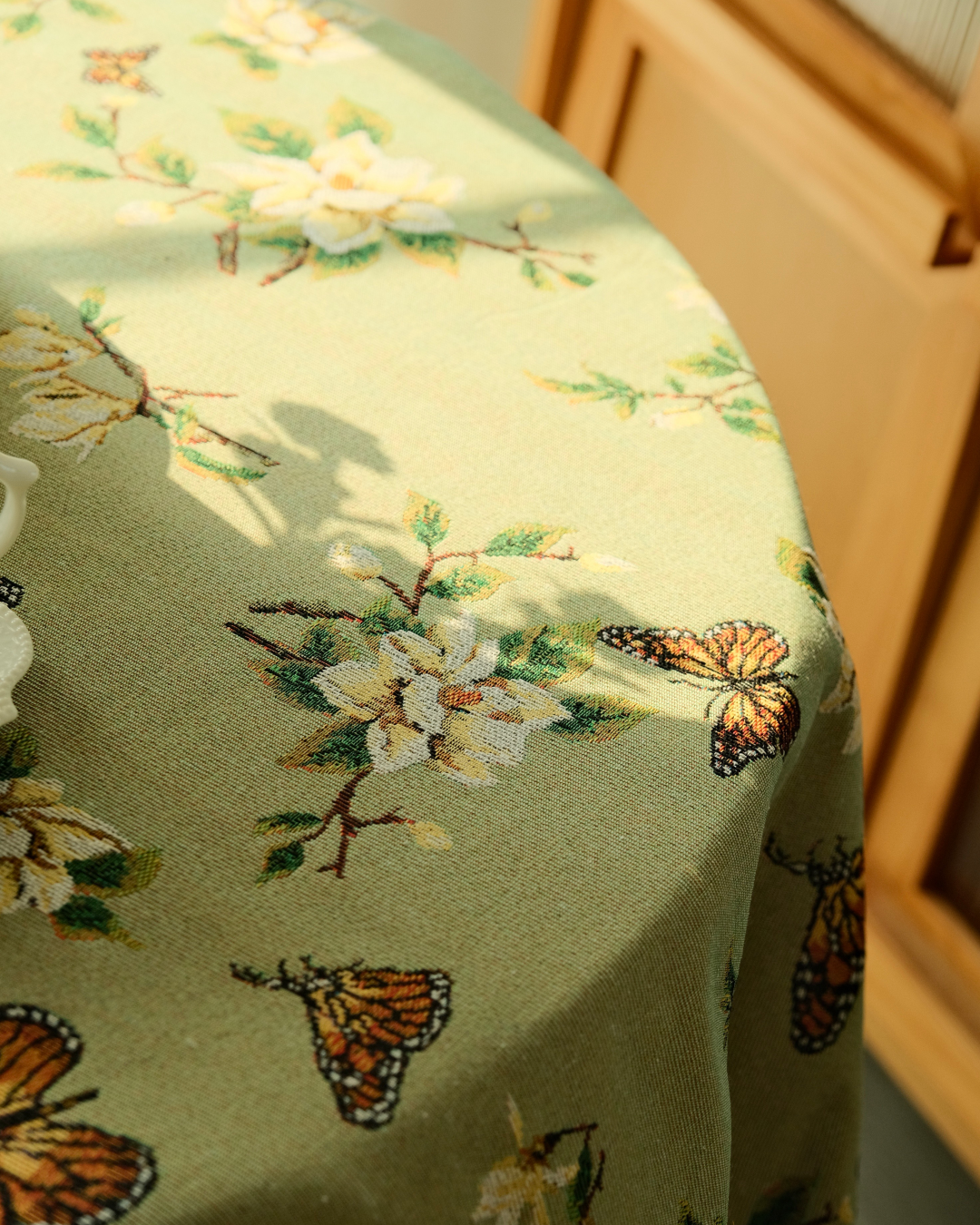 Cottage dining table covered with olive floral tablecloth
