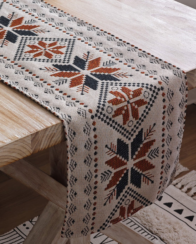 Nordic snowflake table runner with fringe, rust and indigo cotton