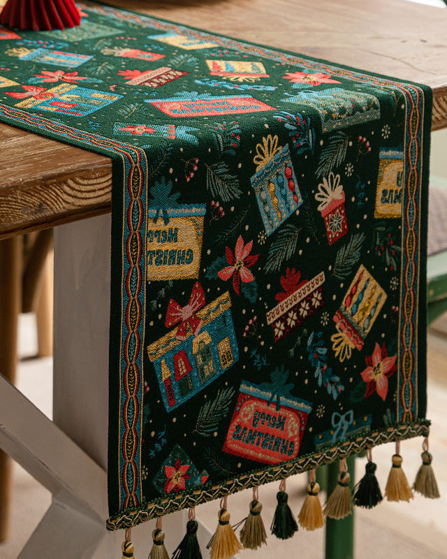 Green Christmas table runner with gifts and poinsettias, gold tassels