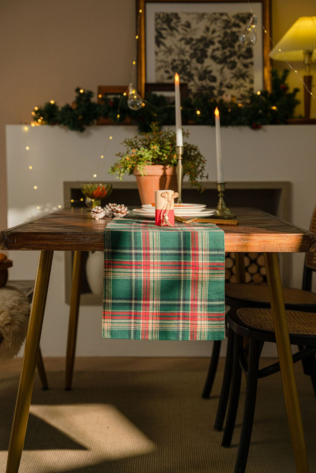 Tartan table runner styled with candles and pinecones