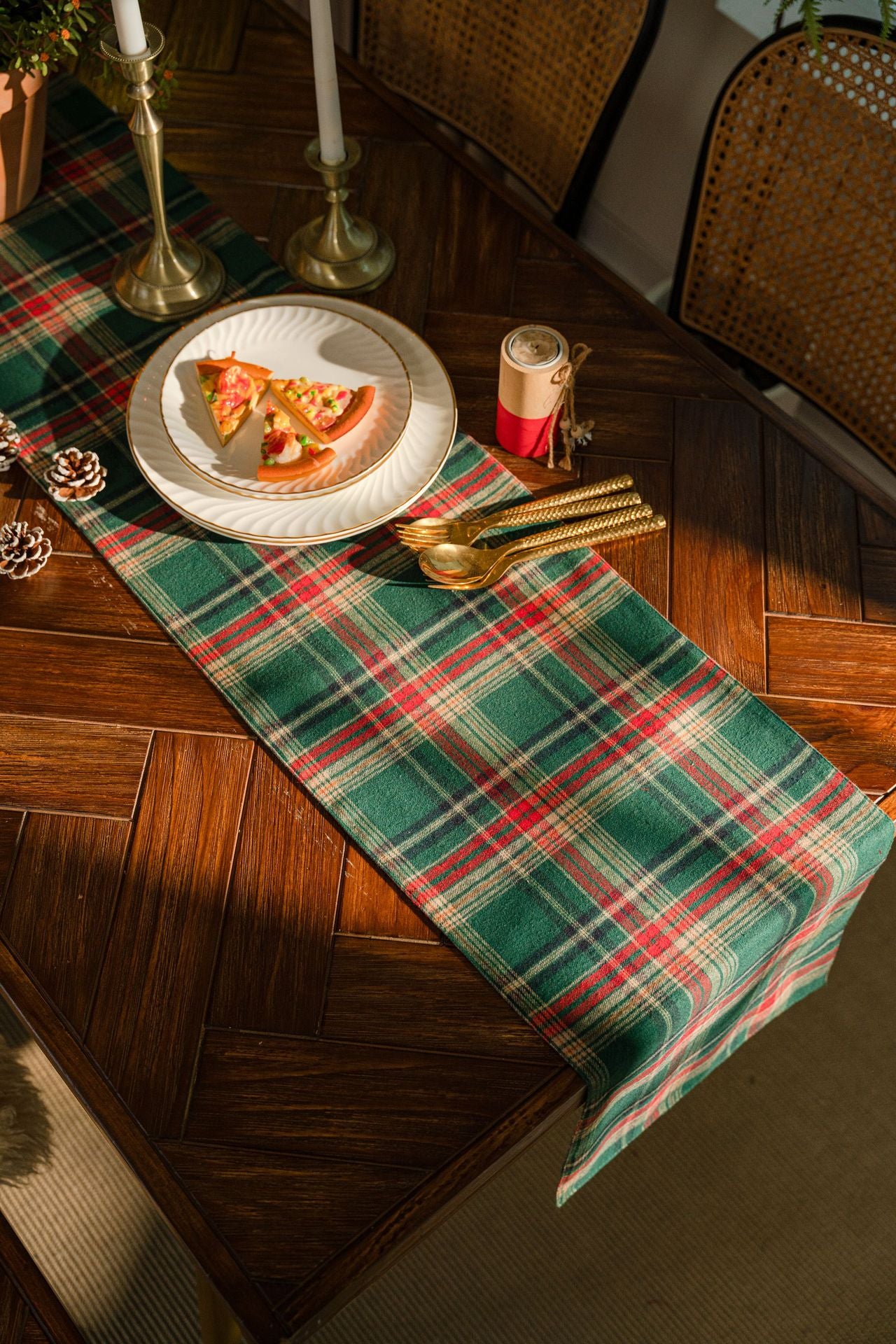 Plaid tablecloth on a wooden table with a slice of pizza on a plate.
