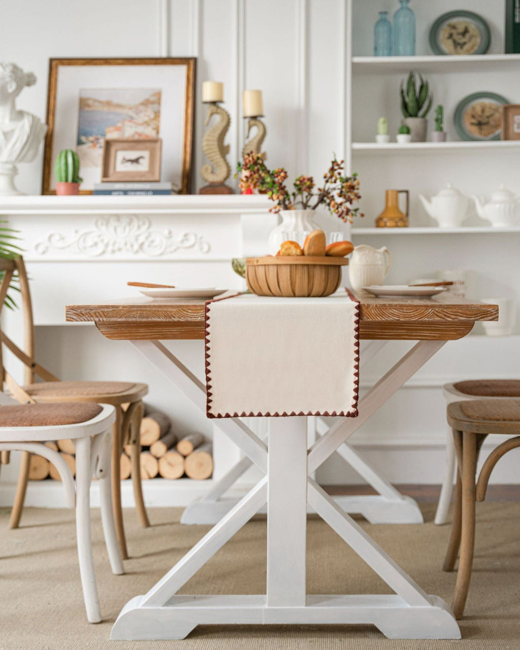 Dining room with a wooden table and chairs, decorated with a basket of fruit and a decorative item on a shelf.