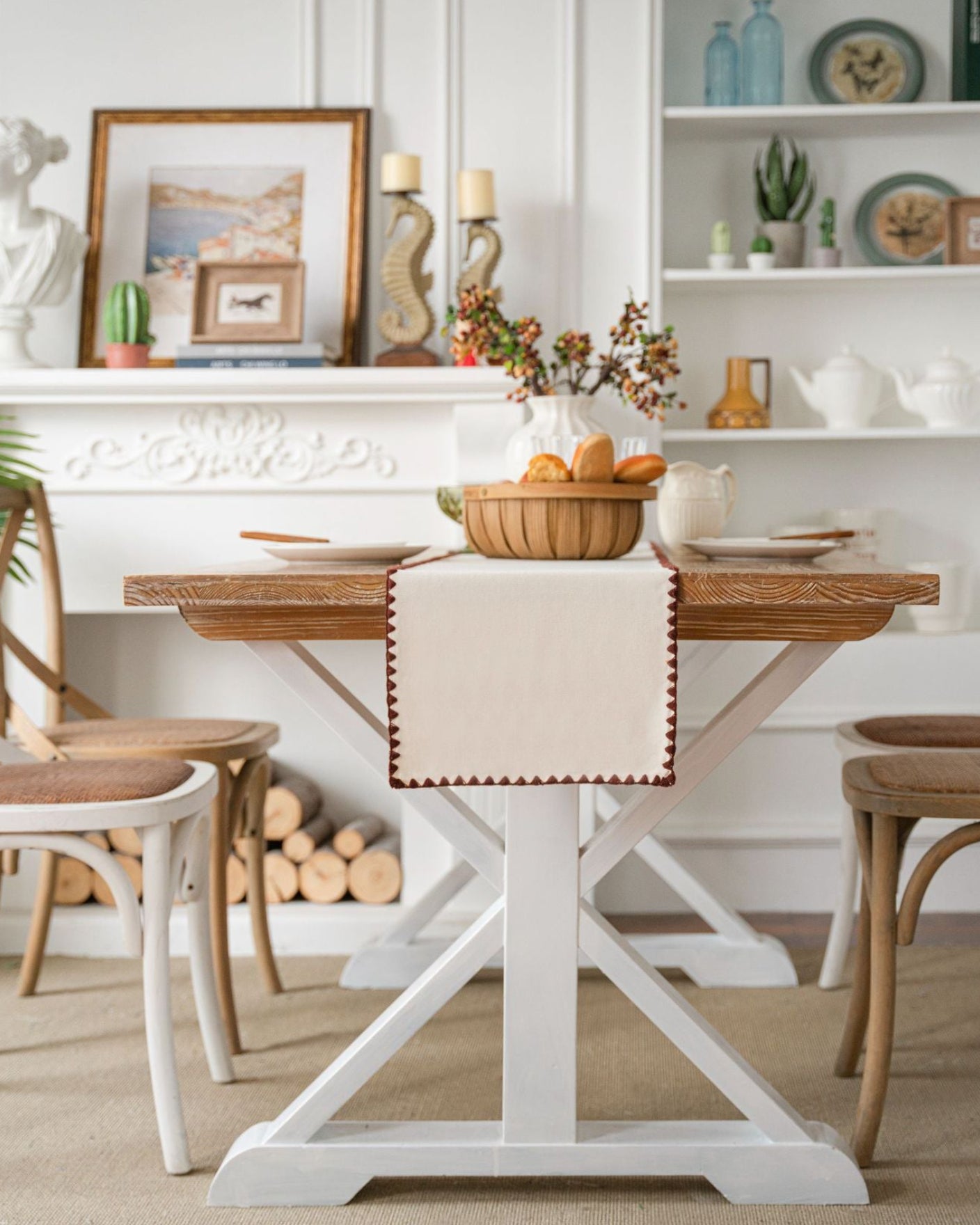 Dining room with a wooden table and chairs, decorated with a basket of fruit and a decorative item on a shelf.