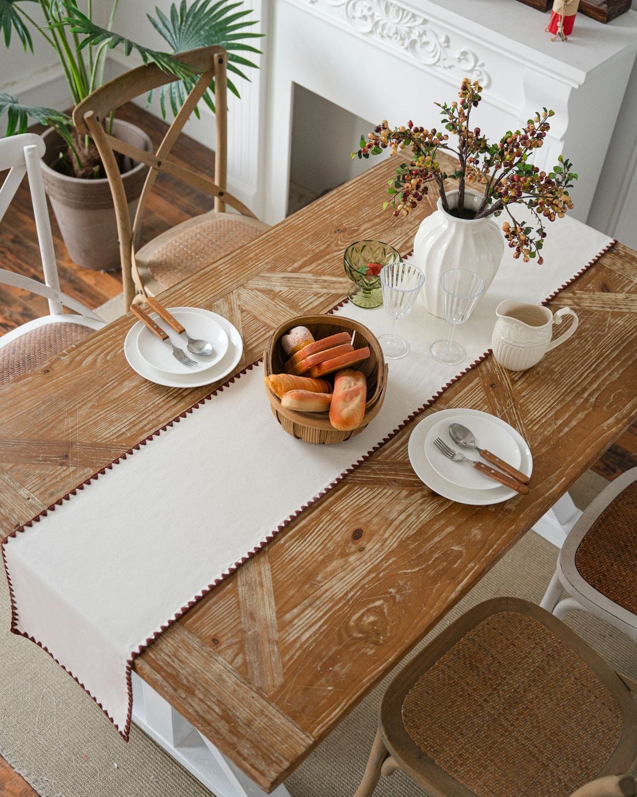 Minimalist cream table runner styled with bread and plates