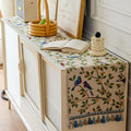 Bluebird branch tasseled table runner on a console table with a basket