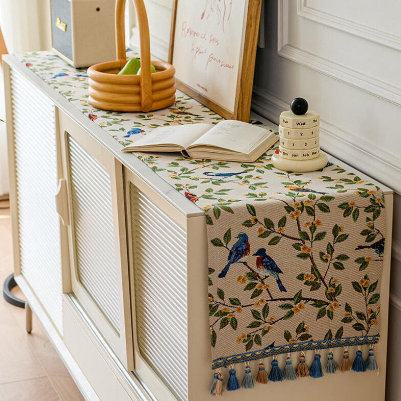 Bluebird branch tasseled table runner on a console table with a basket