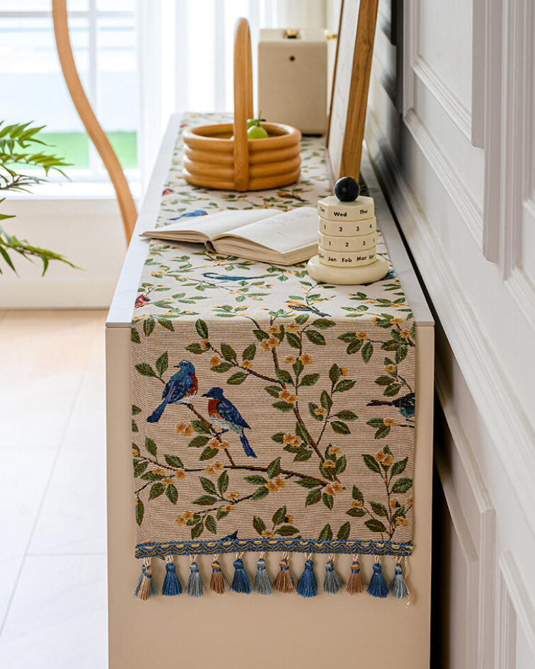 Bluebird branch runner draped over a console table edge with a book