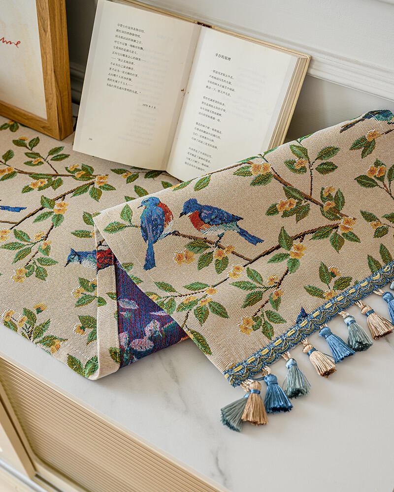 Close view of bluebird and branch print on a console table runner